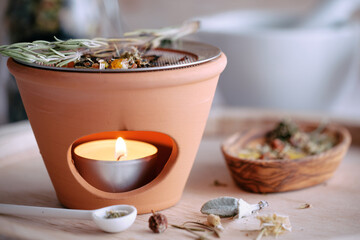 Burning various types of incense in an incense burner with tea light: frankincense, resins,...