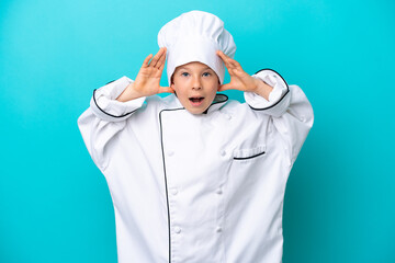 Little chef boy isolated on blue background with surprise expression
