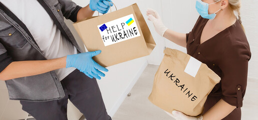 a man holds a box with humanitarian aid to ukraine