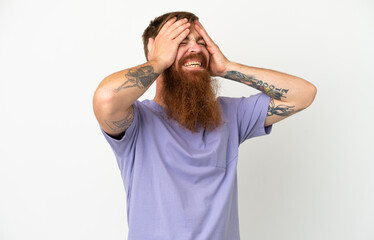 Fototapeta premium Young reddish caucasian man isolated on white background laughing