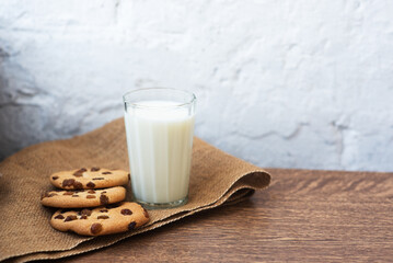 Fragrant, tasty, homemade cookies with raisins and a glass of fresh milk on the table. Delicious, hearty, healthy breakfast. Copy space, high resolution