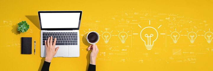 Idea light bulb theme with person using a laptop computer - obrazy, fototapety, plakaty