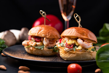 Burgers with fries and various sauces.