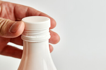 Unscrew the lid of the yogurt bottle. Healthy food. Dairy products.