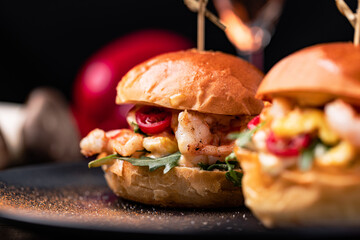 Burgers with fries and various sauces.