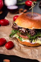 Burgers with fries and various sauces.