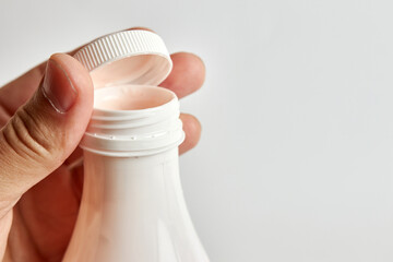 Unscrew the lid of the yogurt bottle. Healthy food. Dairy products.