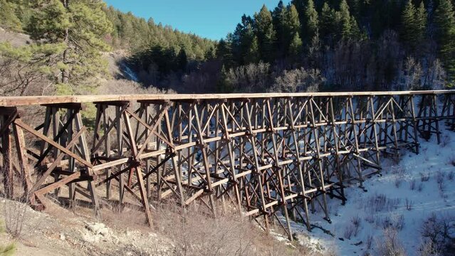 Drone aerial fly-by of an old historic railroad track bridge