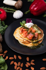 Pouring sose on pancakes. pancakes with salmon and pesto sose . Tasty breakfast food