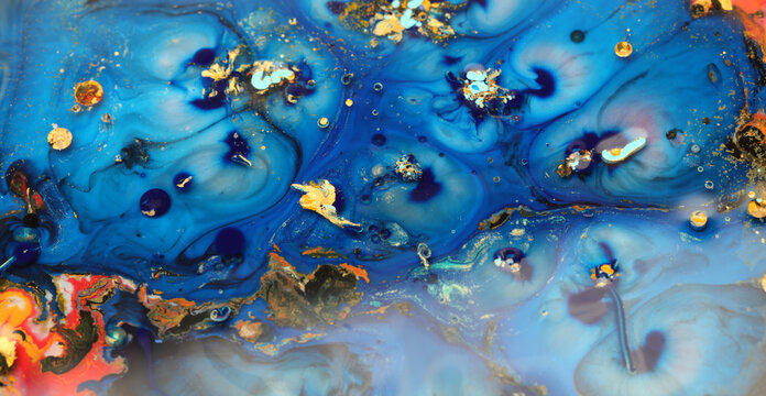 Macro Abstract bubble marble texture background. Acrylic gold and blue color in water and oil.