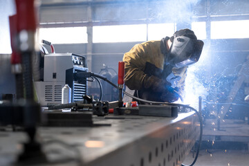 Welder in action with bright sparks.