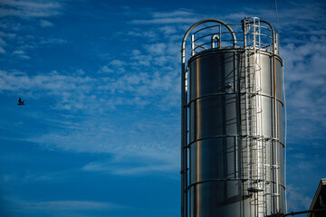 Stainless steel silos in the chemical industry, bulk plastics silo against