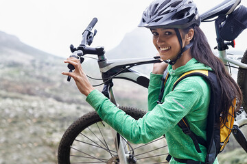 I am an adventurer. A pretty young woman carrying her mountain bike.