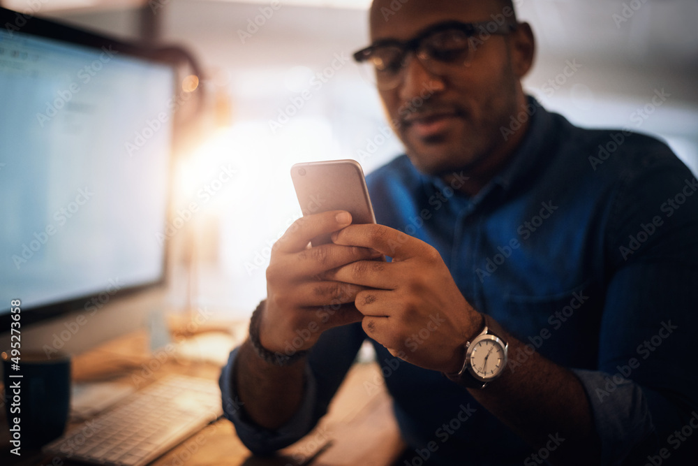 Aufkleber checking in with a few connections. shot of a young businessman using a cellphone in an office at ni