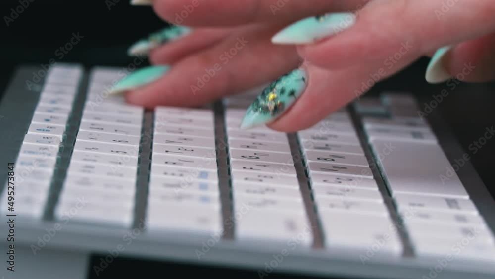 Poster business woman's fingers are typing on the keyboard of a white laptop. the hands of a young girl are
