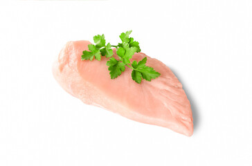 High quality photo of raw boneless chicken breast (fillet) with a piece of parsley isolated on white background.