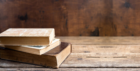 Old books on wooden table. Education learning concept with old book in library. History, religion, antique old books concept. Copy space