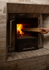 Wood-fired bath. Bath attendant man holds firewood in his hands. Break up the bath.