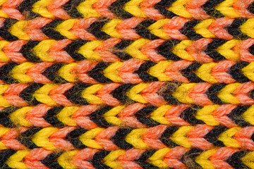 Yellow, red and black synthetic knitted fabric texture