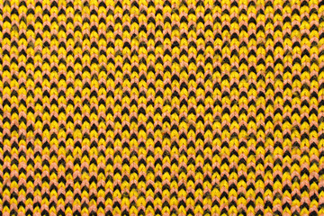 Yellow, red and black synthetic knitted fabric texture
