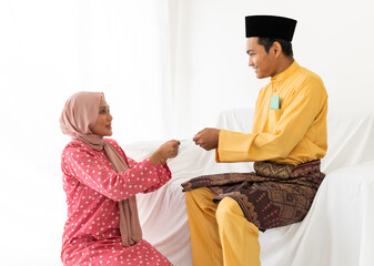 Muslim young couple celebrates Eid Al Fitri Hari Raya Aidilfitri end of ramadan, the Islamic holy...