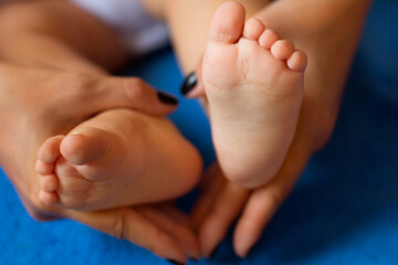 The woman tenderly embraced the baby's legs