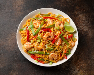 Stir fry noodles with prawns and vegetables in white plate. Healthy asian food