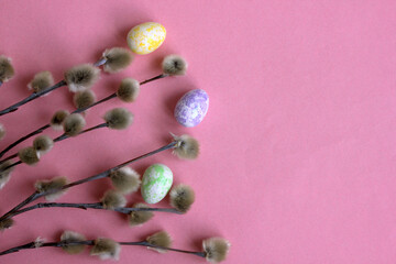 A bouquet and you on a pink background with Easter eggs. Beautiful fluffy sprigs of willow, blooming on a pink table, view from above. Easter flower card, spring flowers and plants. Copy space