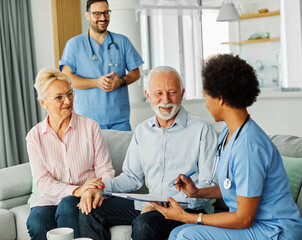 nurse doctor senior couple care caregiver help assistence retirement home nursing elderly man woman...
