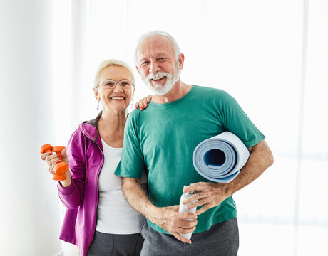 senior active exercise  woman man couple training sport fitness mat gym fit pilates home love together family healthy smiling happy elderly water bottle