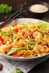 Stir fry noodles with prawns and vegetables in white plate. Healthy asian food