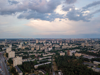 Fototapeta premium Sunset over Kiev. Rain clouds in the sky. Aerial drone view.