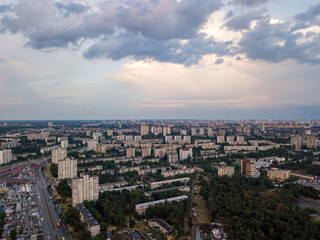 Fototapeta na wymiar Sunset over Kiev. Rain clouds in the sky. Aerial drone view.