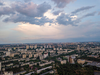 Fototapeta na wymiar Sunset over Kiev. Rain clouds in the sky. Aerial drone view.