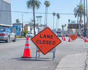 A lane closed sign is posted on Sunset Boulevard to help commuters navigate a busy construction...