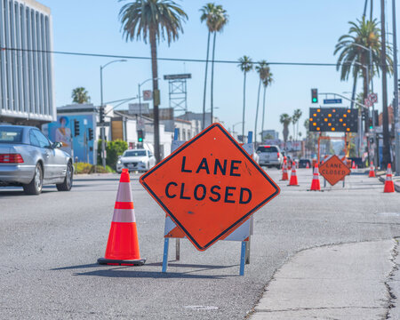 A lane closed sign is posted on Sunset Boulevard to help commuters navigate a busy construction area.