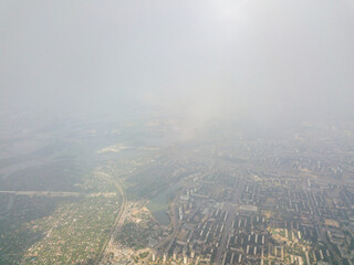Kyiv city through high clouds. Cloudy day. Aerial drone view.