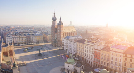 Main Square in Kraków Centre down town. Rynek Główny drone aerial view from above. Beautiful soft morning light to histirical architecture of the old city. Poland