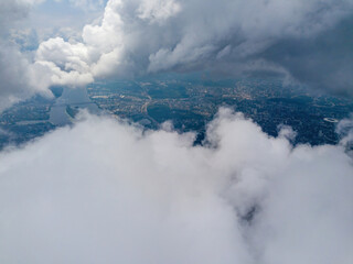 Kyiv city through high clouds. Cloudy day. Aerial drone view.