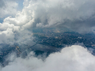 Fototapeta premium Kyiv city through high clouds. Cloudy day. Aerial drone view.