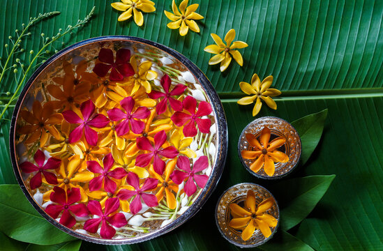 Pure water bowls decorating with flowers and perfume, on banana leaf for Lao New Year or "Pi Mai Lao". Songkran festival.