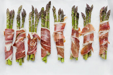 Asparagus with ham on white background