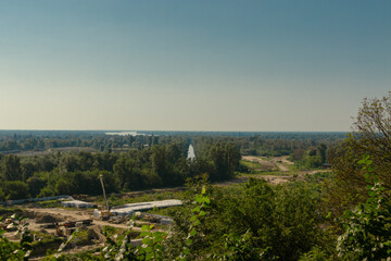 Forest with a river and a construction site. Construction in the forest