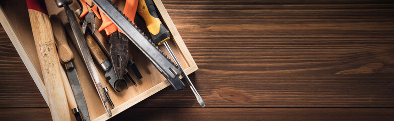 different construction tools on wooden background