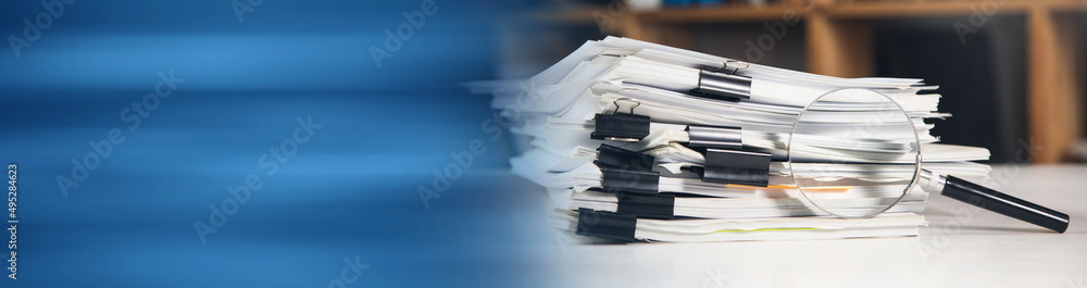 Aufkleber stack of report paper documents with magnifying glass