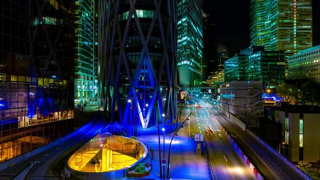 Night Trip in La Defense Business District Street With Traffic Between Buildings