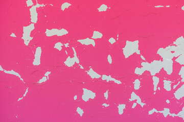 Photo of an aged, weathered pink colored stucco on a wall in a slight out of focus, to use as a background