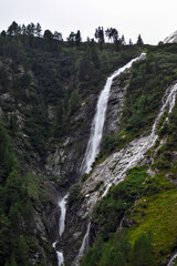 Fototapeta na wymiar Beautiful waterfall in the mountains (alps). Scenic valley in Kärnten, Austria.