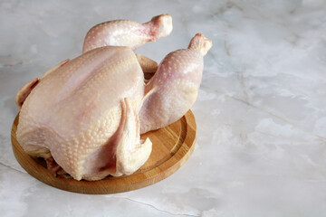 plucked chicken, a whole raw carcass of a bird.