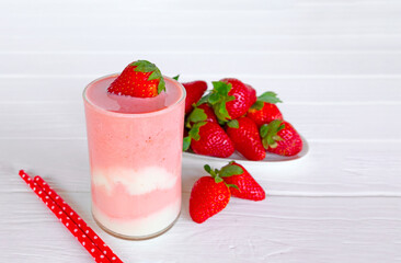 Strawberry yogurt fruit juice smoothie pink colorful fruit juice milkshake blend beverage healthy high protein the taste yummy In glass drink episode morning on white wood background.